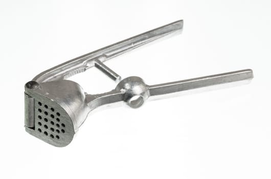 Garlic press isolated against white in macro shot
