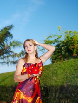 Young woman with flowers outdoor