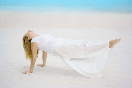 Woman meditating near ocean. Feet out of earth