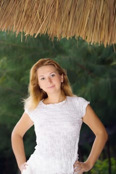 Young woman posing over natural green background