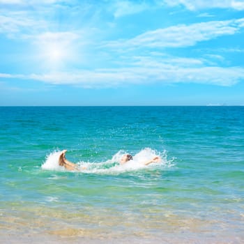 Funny man making splash in the ocean