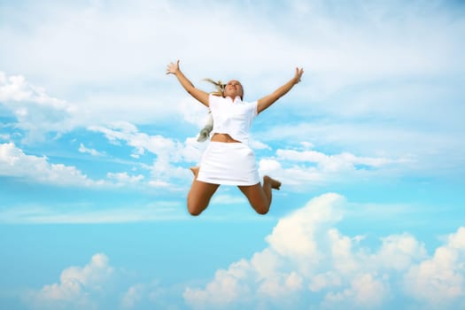 Young woman jumping in cloudy sky
