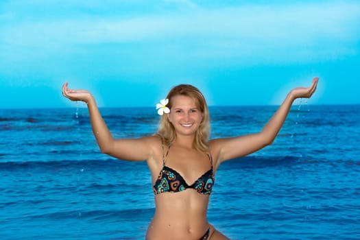 Happy young woman with water in her hands