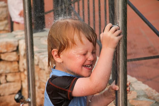 Boy taking a shower outside