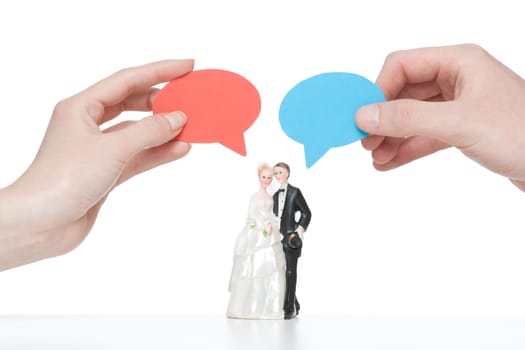 Say yes - wedding figurines (bride and groom) with cartoon bubble hold i hand by real woman and man.