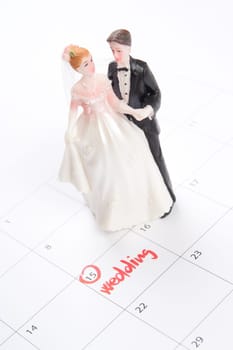 Word wedding in calendar and wedding figurines - planning a wedding concept