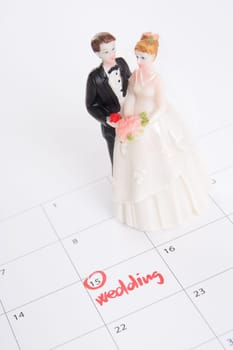 Word wedding in calendar and wedding figurines - planning a wedding concept