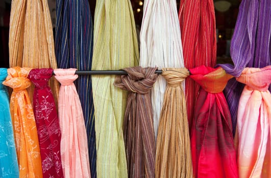 bolts of fabic or scarves hanging for sale