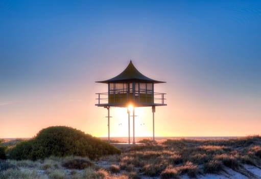 sunset behind surf life savers rescue lookout station