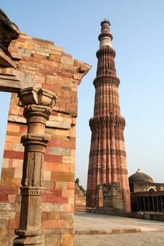 Qutub Minar with portion of surrounding structure in Delhi, India, Asia
