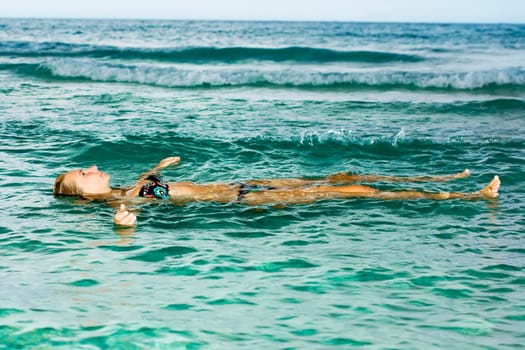 Woman relaxing in the tropical lagoon