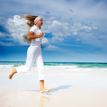 Young woman running on the beach