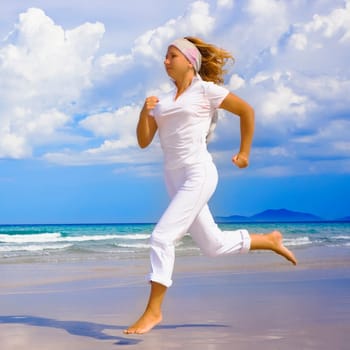 Young woman running on the beach