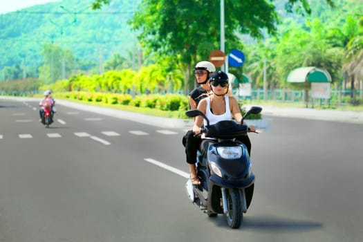 Two tourist woman riding motorbike on road. Vietnam