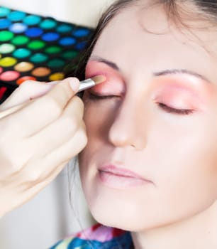 Woman in beauty salon reading for make-up