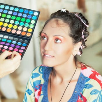 Woman in beauty salon reading for make-up
