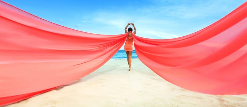 Woan with red scarf on the beach
