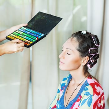 Woman in beauty salon reading for make-up