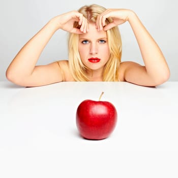 Young beautiful laughing girl with apple against white background