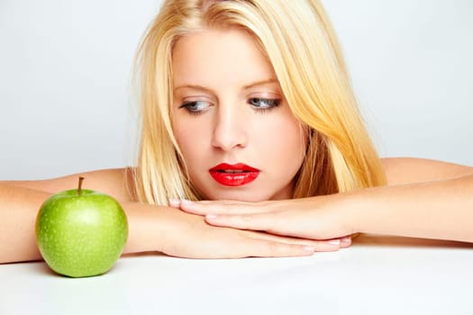 Young blonde woman with apple