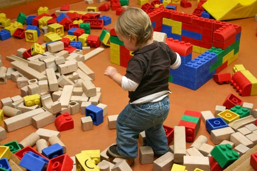Little boy playing with building blocks