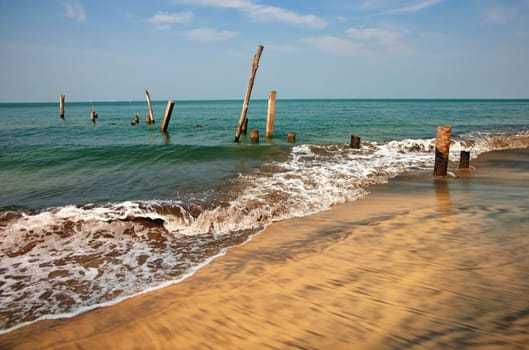 pillars from an old jetty stand in the sea