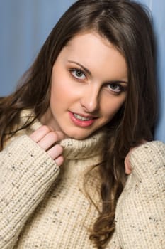 Beautiful smiling winter woman wearing beige sweater portrait