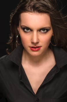 Portrait of young beautiful woman on dark background