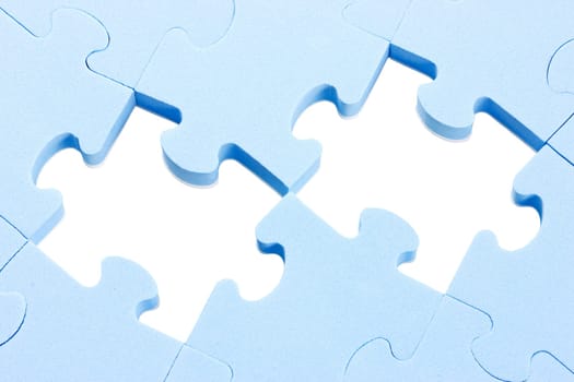 blue puzzle background with two missing pieces