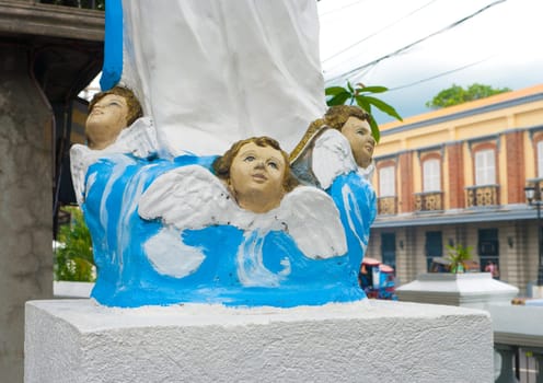 three small angels as part of a larger statue