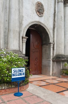 shield in front of a church saying that a mass in going on