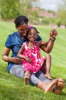 Portrait of a adorable african mother with her daughter in the garden