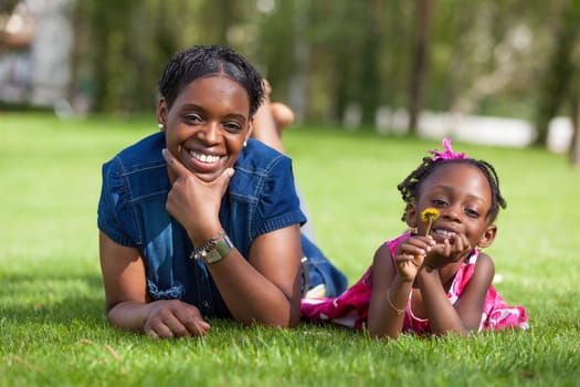 Portrait of a adorable african mother with her daughter in the garden