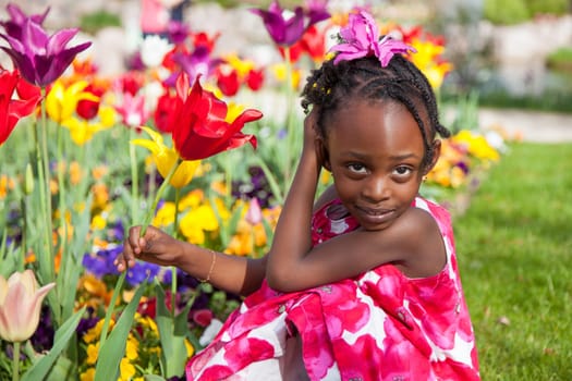 Portrait of a cute little african american girl playing in the garden