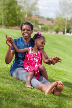 Portrait of a adorable african mother with her daughter in the garden