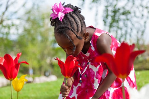 Portrait of a cute little african american girl playing in the garden