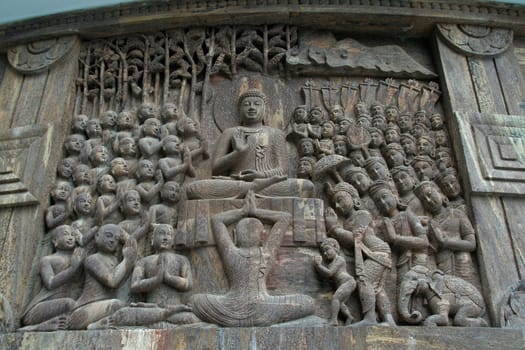 Buddha delivering sermon while humble devotees listen attentively in a stupa in Darjeeling, India, Asia