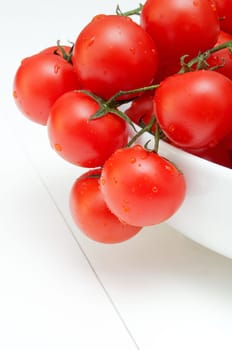 Closeup of Bunch of Fresh Cherry Tomatoes in White Bowl