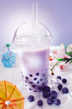 Bubble tea blended with milk and black currant berries and purple boba or pearls