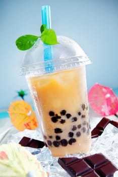 Iced drink with chocalate and a touch of green leaves on top for contrast