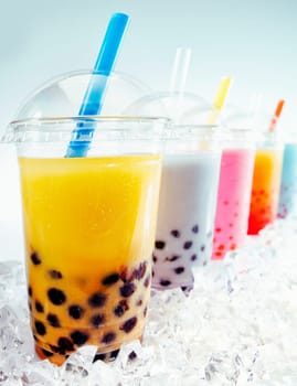Assorted Fruity Boba Tea Cocktails in a row on crushed ice