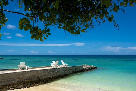 Beach chairs on pier. Coast of Indian ocean. Maldives