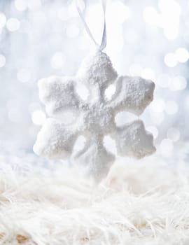 Bright Snow flake on defocused white background with bokeh
