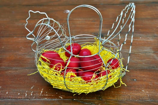 Vintage chicken shaped basket with red painted easter eggs.