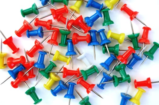 Colorful push pins on white background.