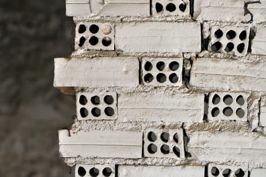 Broken grungy white brick wall background texture.