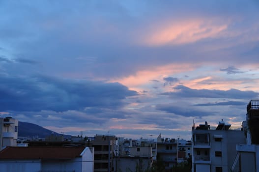 Dawn over the city of Athens, Greece. Sunrise colors and cloudy sky.