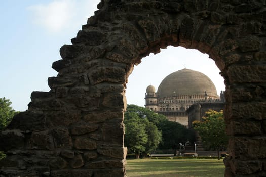 World famous Gol Gumbaz framed with opening in stone wall, Bijapur, Karnataka, India, Asia