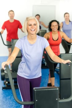 Young fitness woman at treadmill running class at the gym