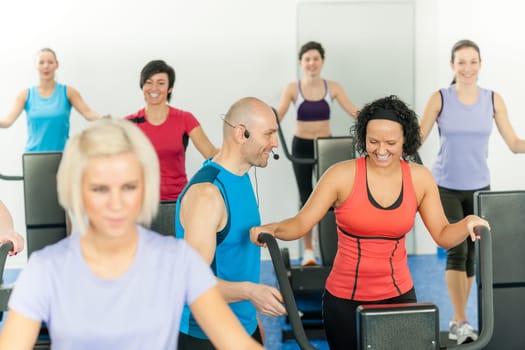 Fitness instructor leading class of alpinning at the gym